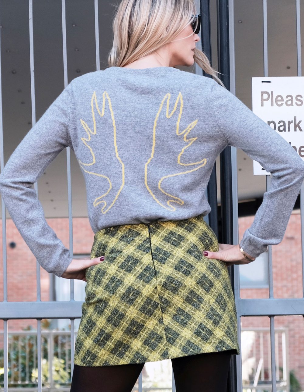 A woman wearing an Antlers cashmere Intarsia knit by Malin Darlin.