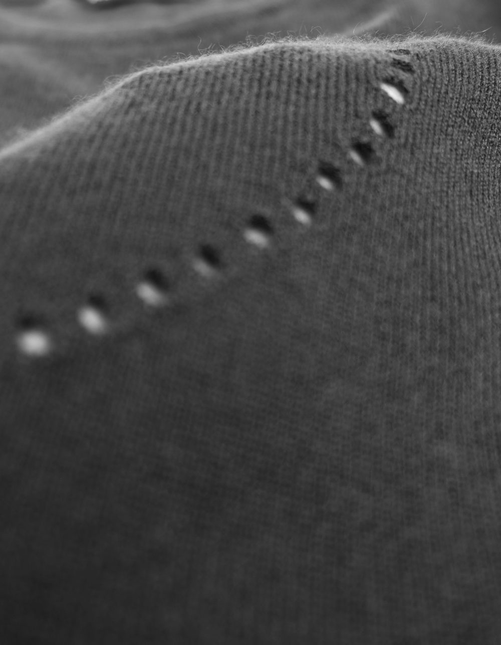 Close up detail of the Heart Holes cashmere jumper by Malin Darlin.