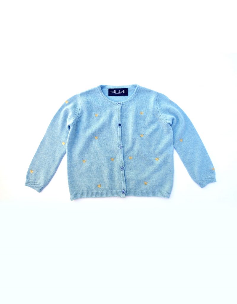 The blue malin darlin cashmere baby cardigan laid flat against a white backcloth.