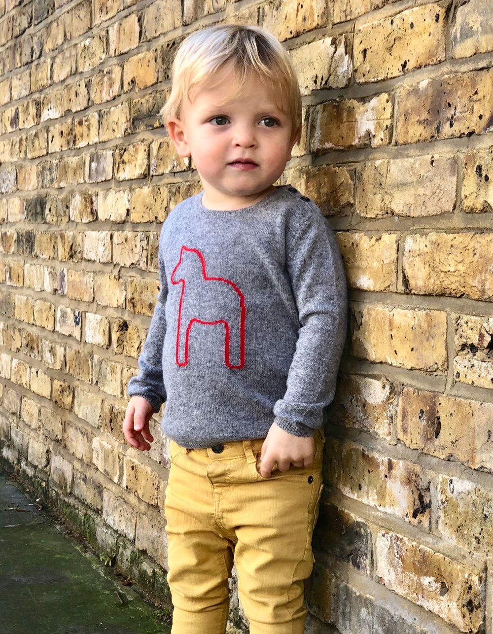 A cute toddler modelling malin darlin childrens cashmere, the baby pony kids cashmere jumper.