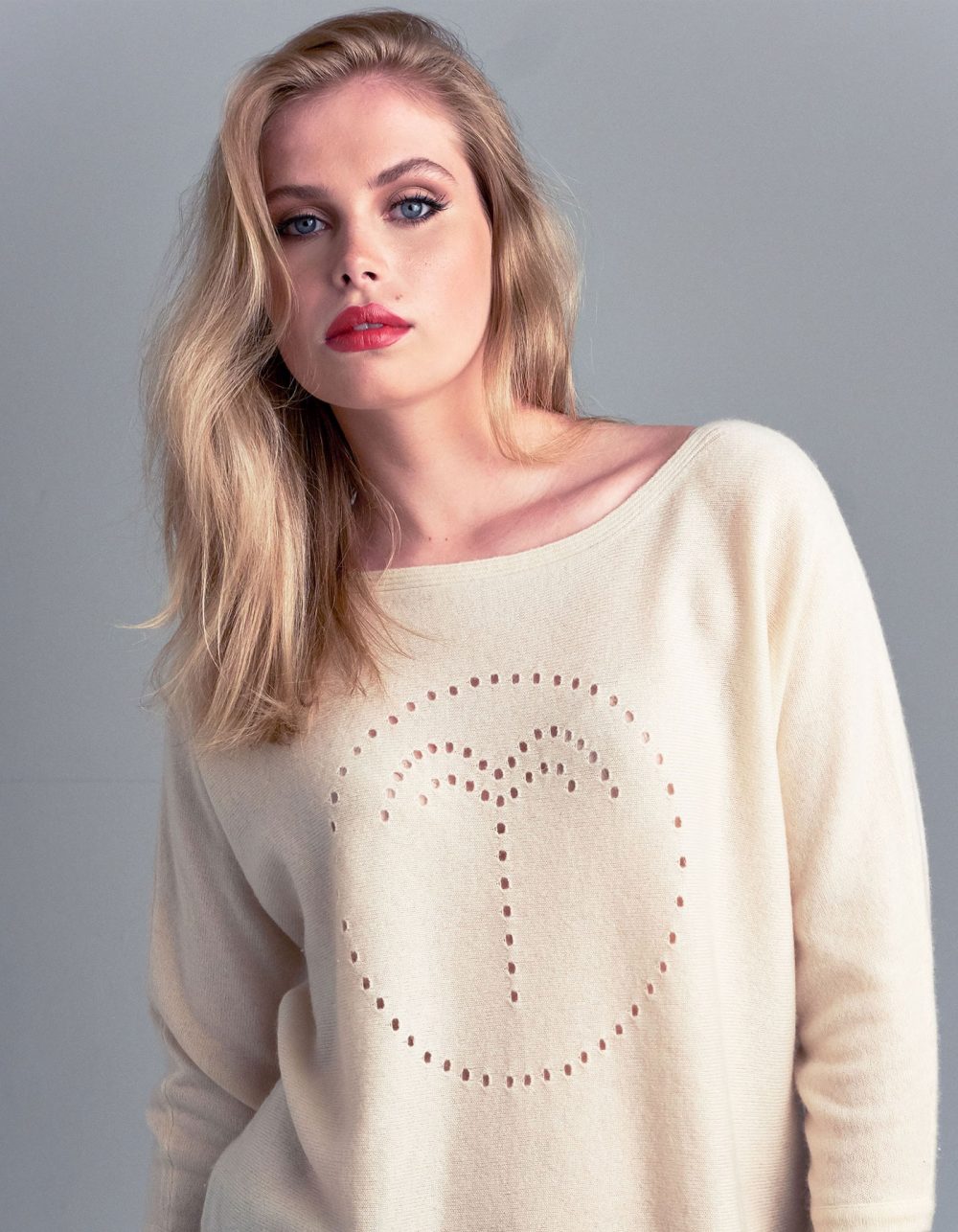Studio photo of a model wearing a cashmere palm jumper in cream, part of the malin darlin designer cashmere collection.