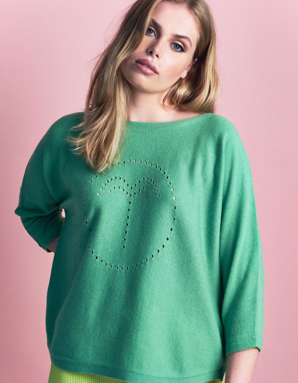 A model wearing the cashmere palm jumper in pitch green, part of the malin darlin range of designer cashmere jumpers.