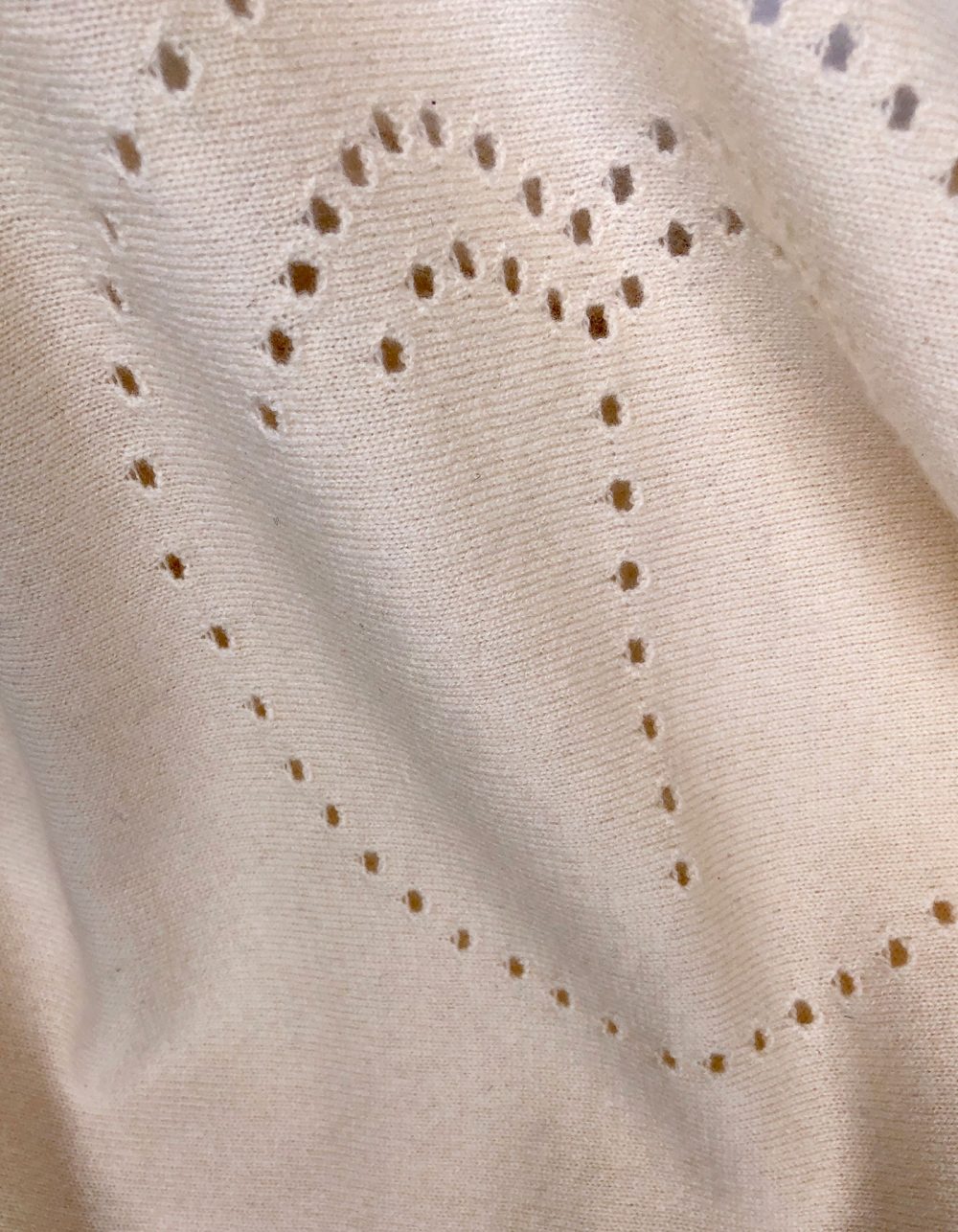 Close up detail of a cashmere palm jumper in cream, part of the malin darlin designer cashmere range of knitwear.