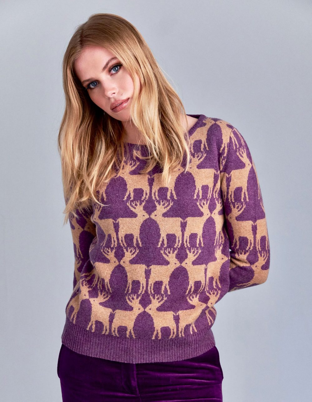 Purple ad beige designer cashmere jumpers with reindeer patterning.