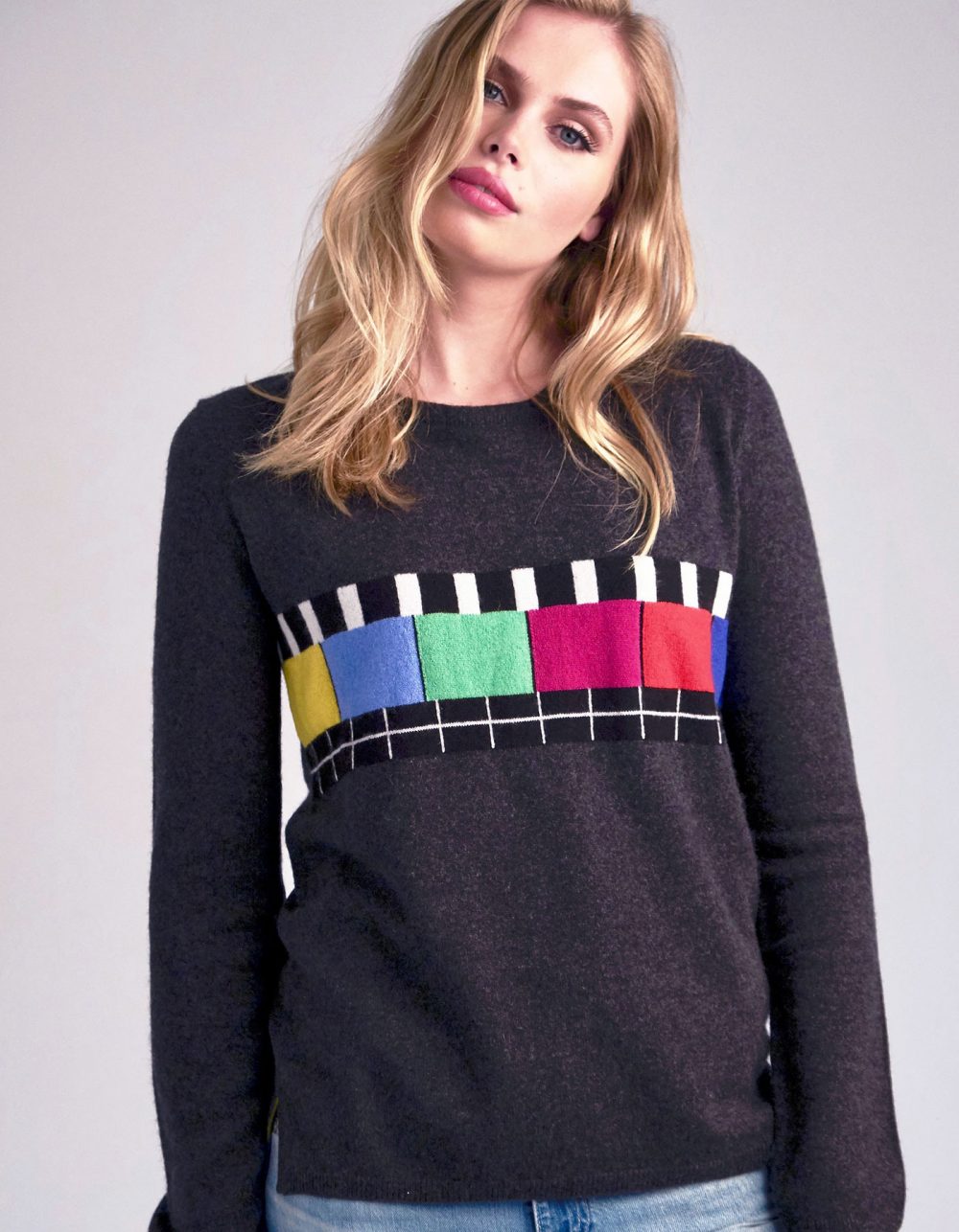 Multi-colour pattern on a charcoal grey cashmere jumper.
