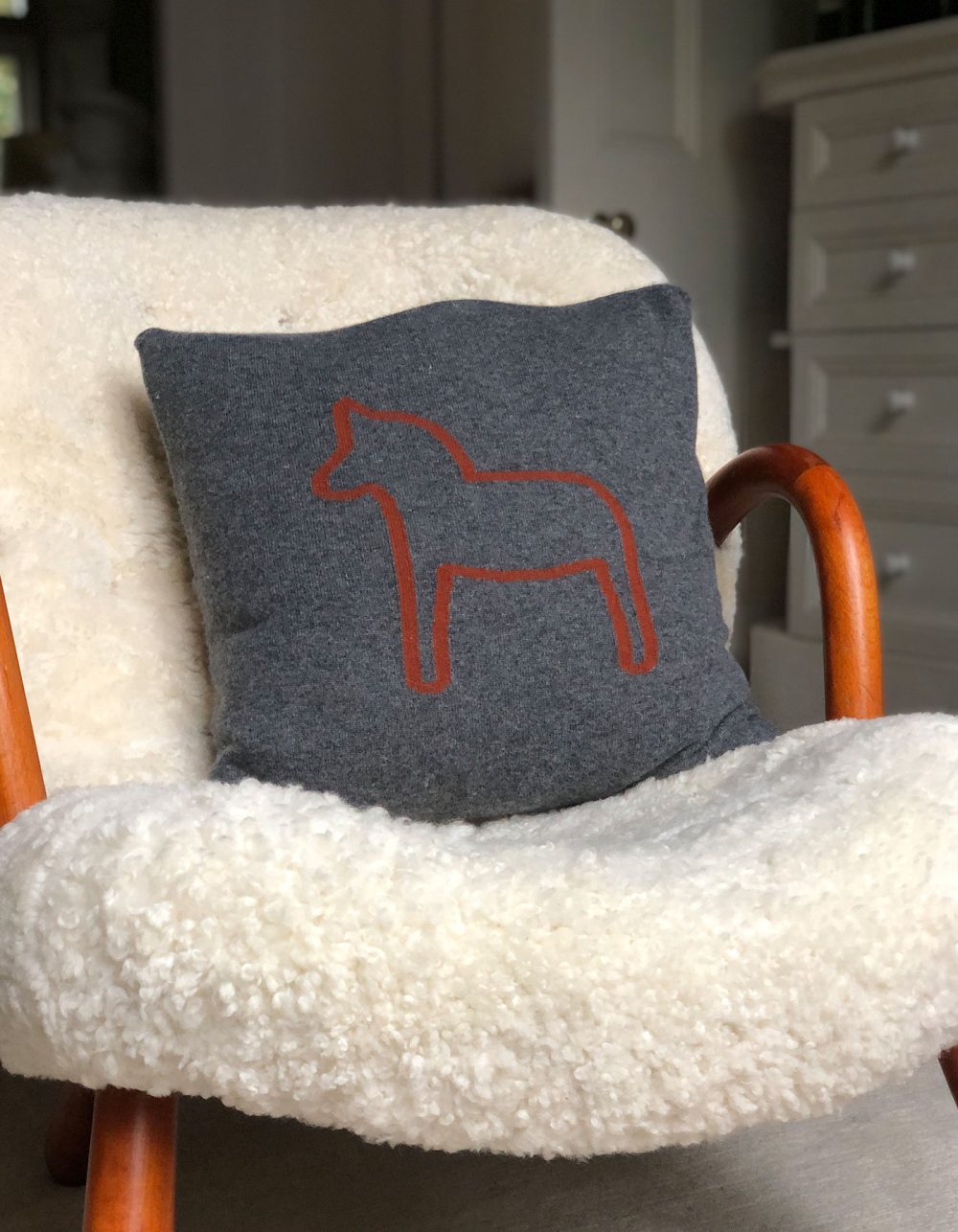 Image of a grey designer cashmere cushion cover, part of the malin darlin range of cashmere gifts.