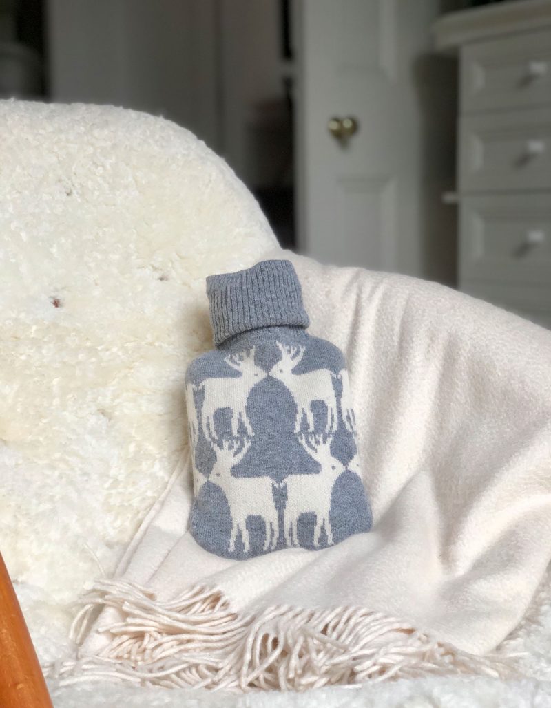 Cashmere hot water bottle on a chair, part of the malin darlin range of designer cashmere gifts.