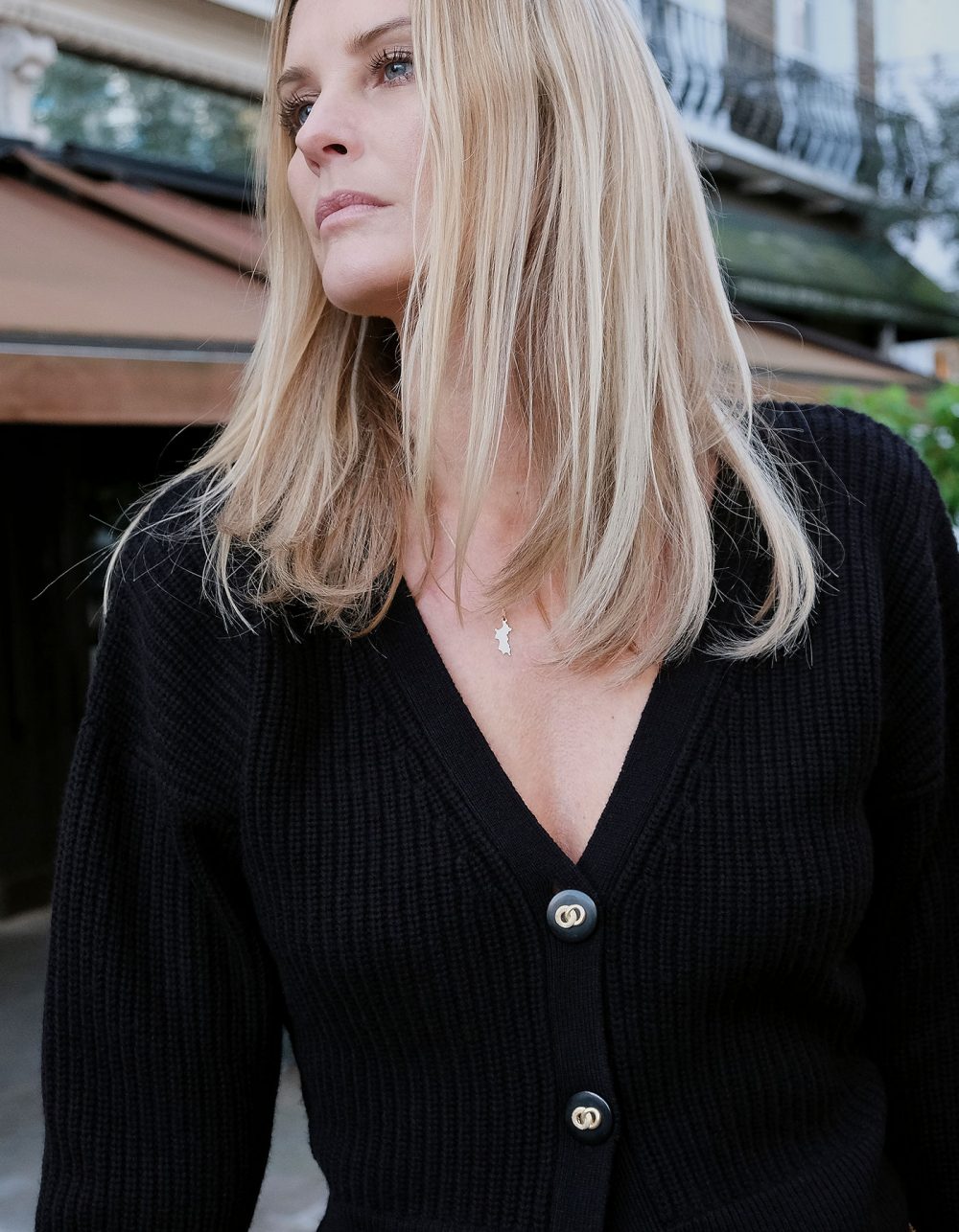 Close up picture of a model wearing the malin darlin black Coco rib wool and cashmere cardigan.