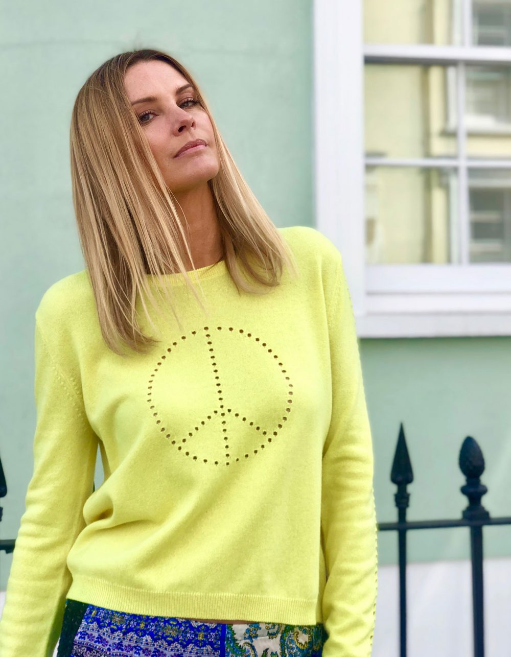 A citronella yellow cashmere jumper with peace symbol design in the pointelle knit.